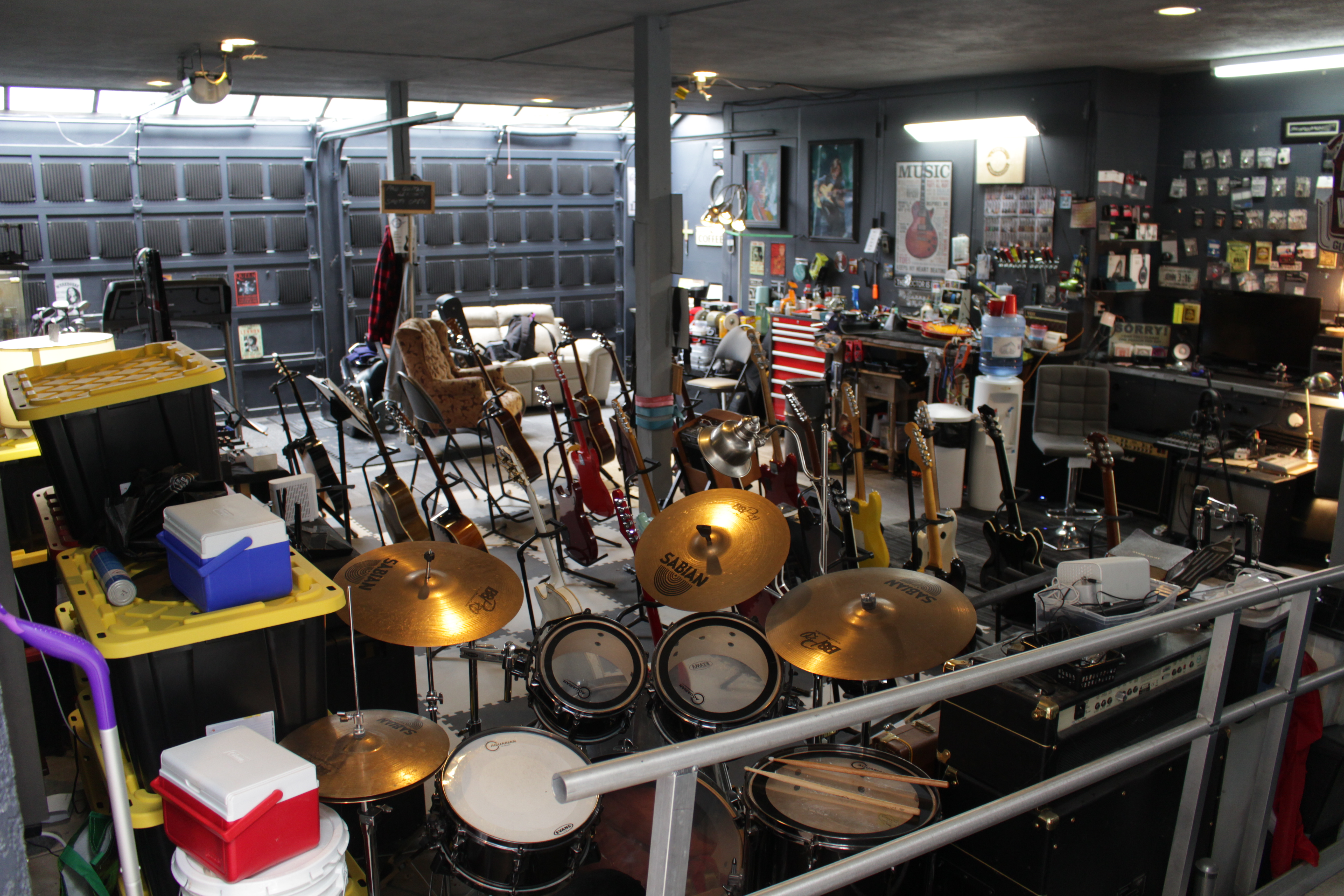 Professional guitar workshop with multiple guitars and equipment in climate-controlled environment