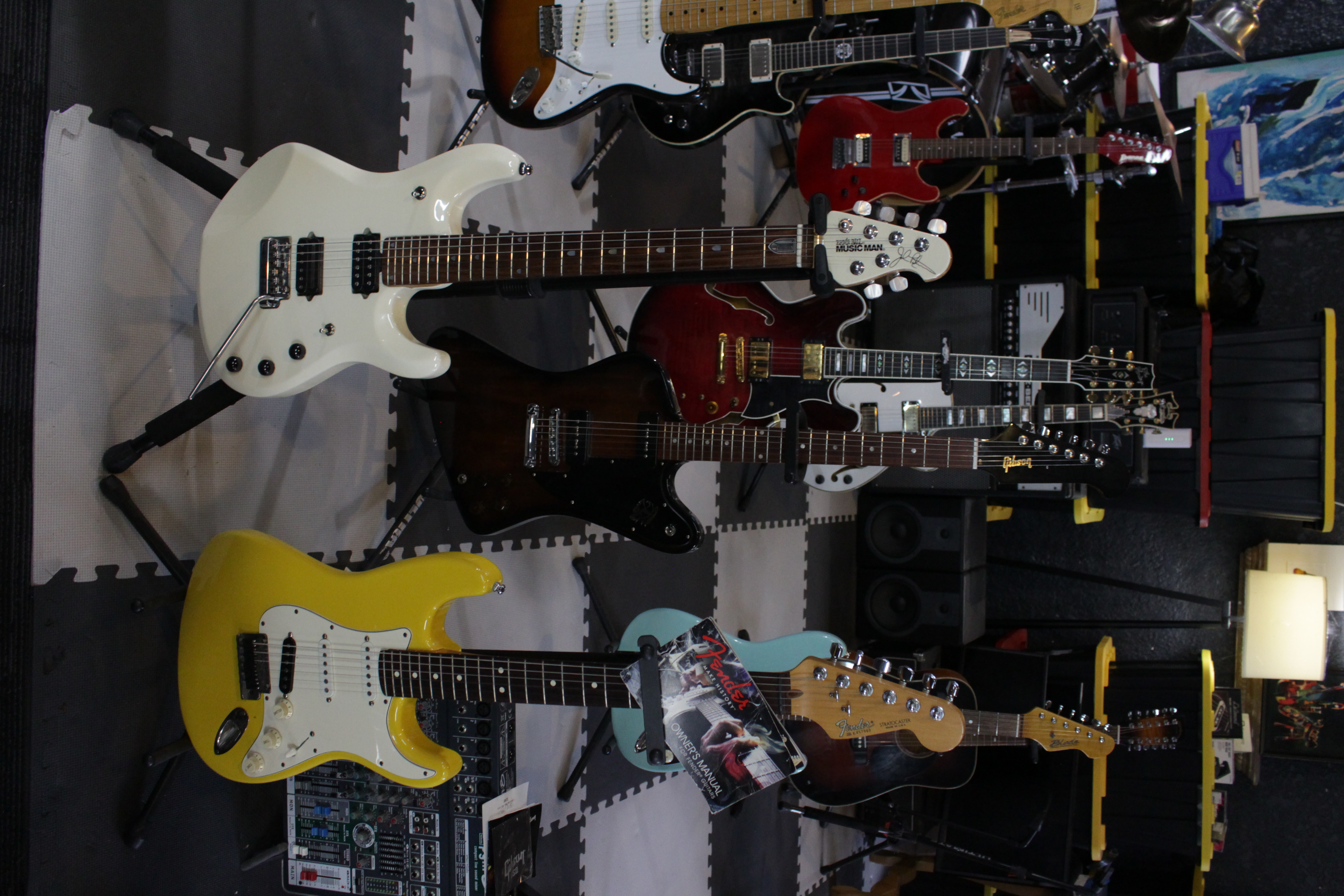 Organized display of electric guitars featuring various models and colors