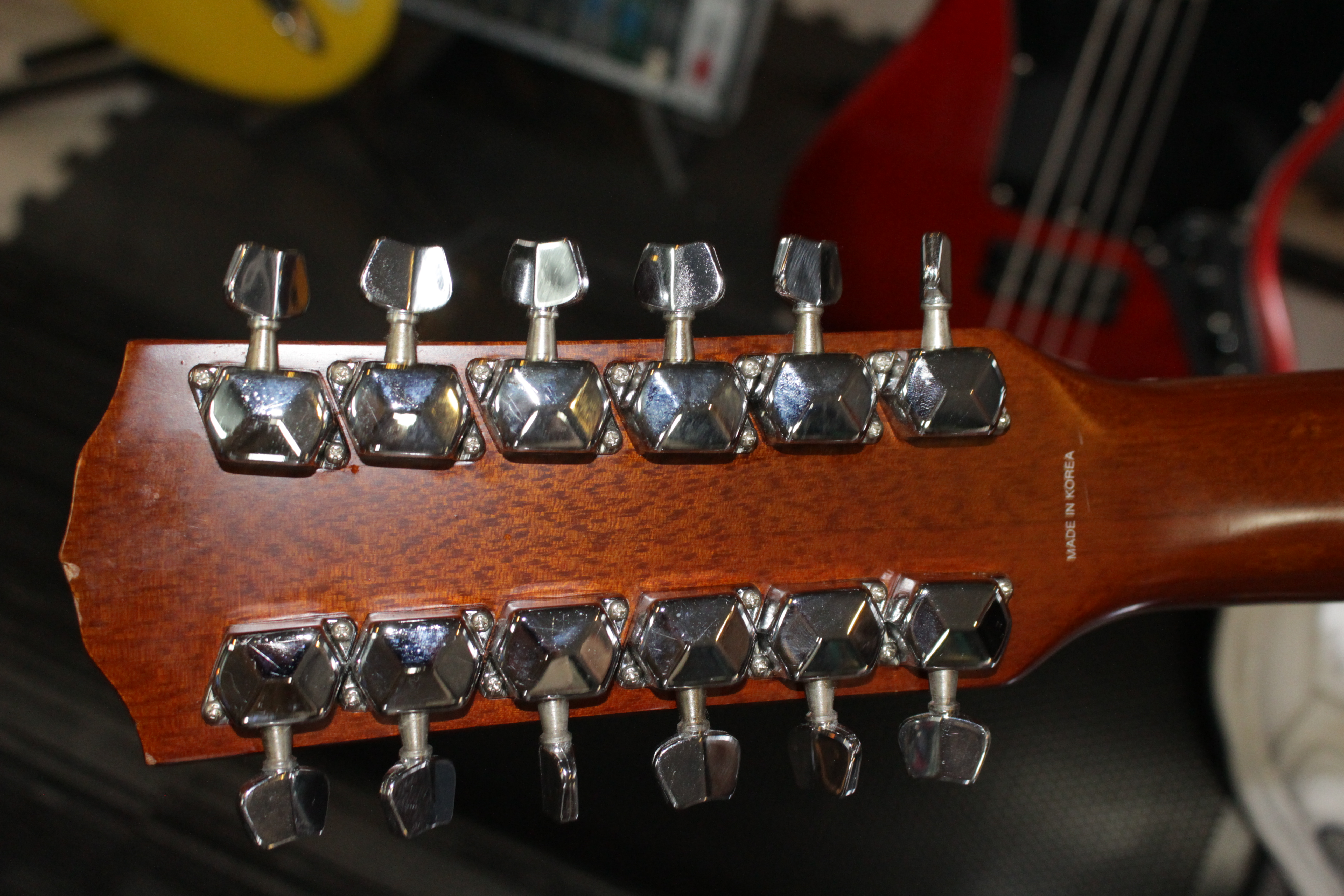 Close-up of 12-string acoustic guitar headstock showing premium tuning machines