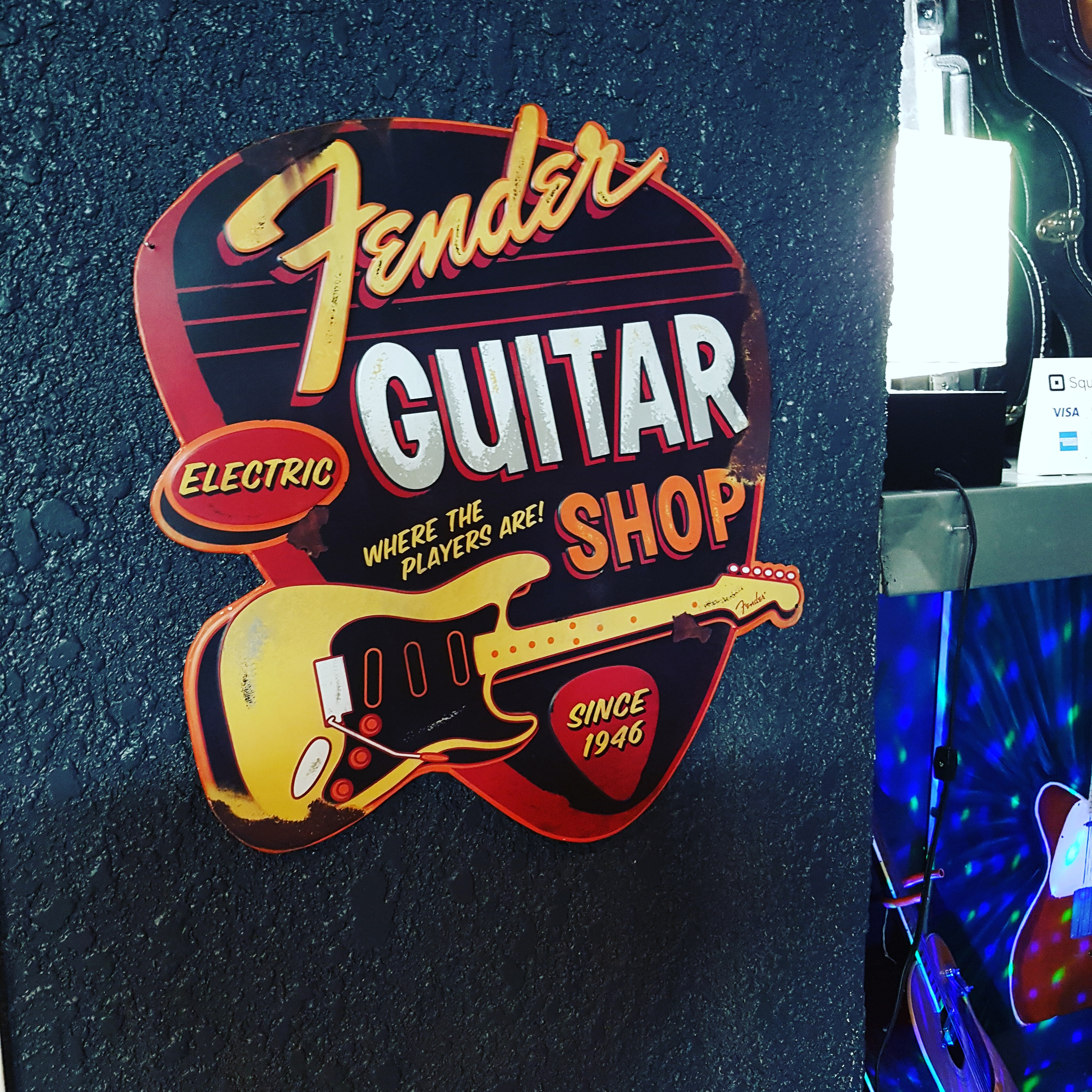 Vintage Fender guitar shop sign at GuitarGarage Music Studios