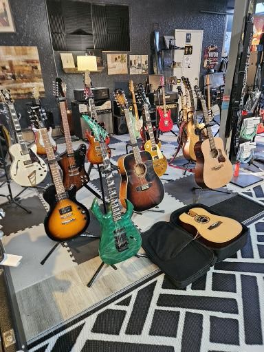 Premium guitars for sale including acoustic and electric models on showroom floor