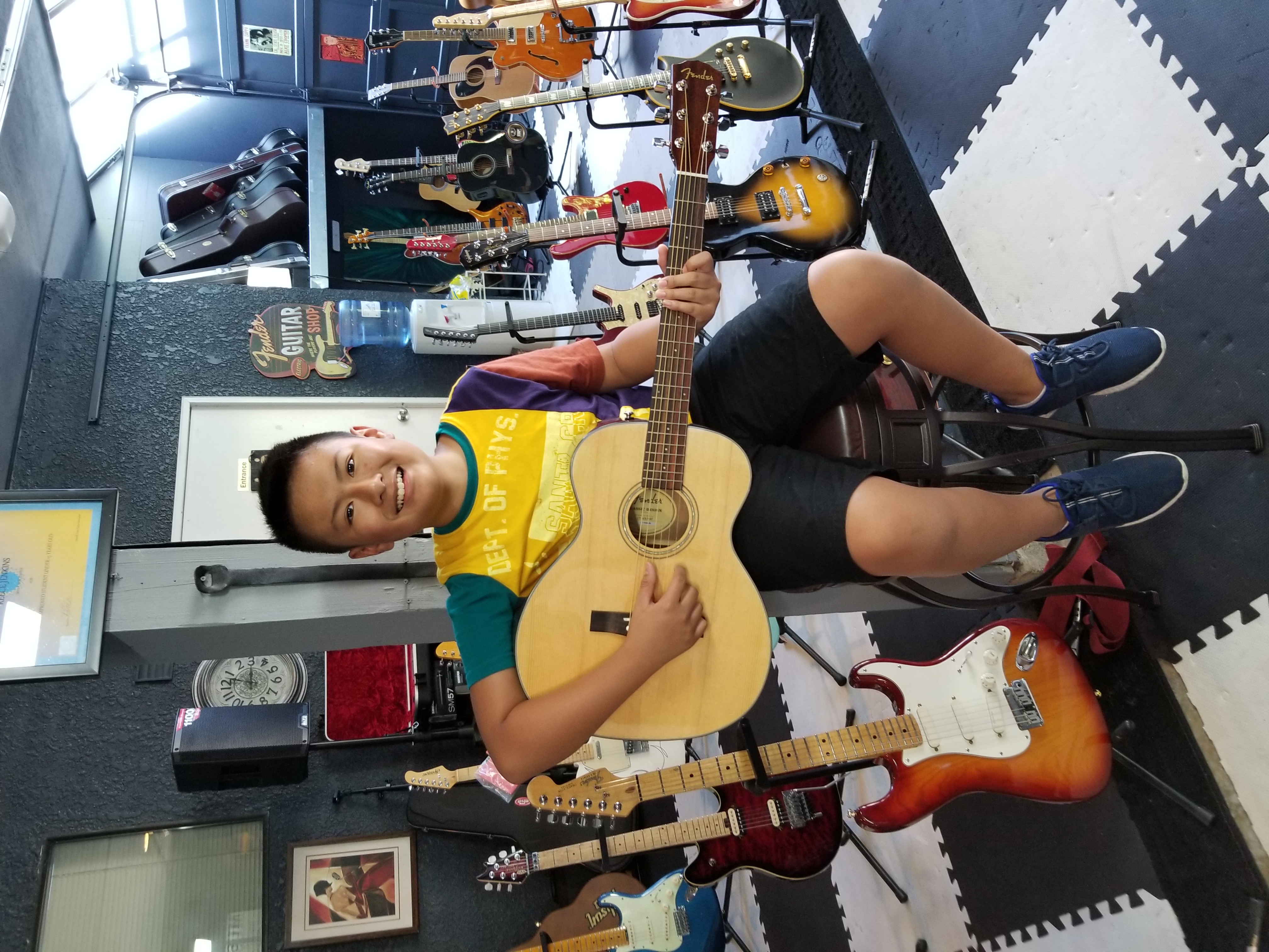 Student learning guitar at GuitarGarage with instructor guidance